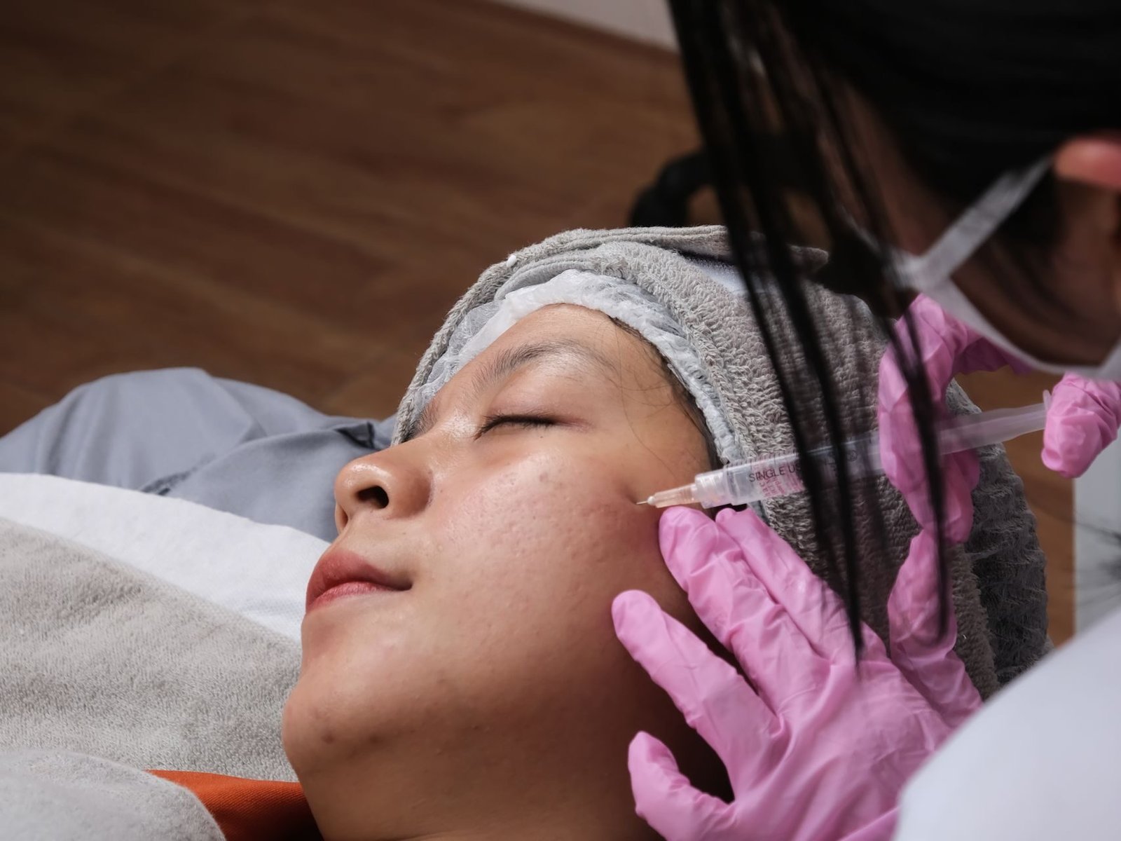 Aesthetic treatment being administered in a clinic setting, showcasing professional care.